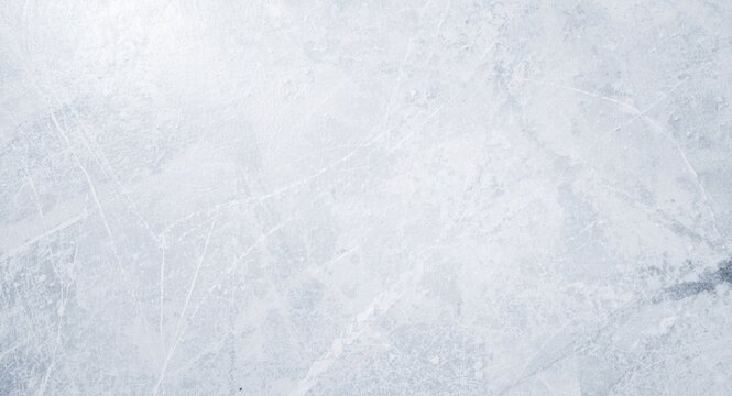 Empty ice rink surface with skate marks and copy space for text or design