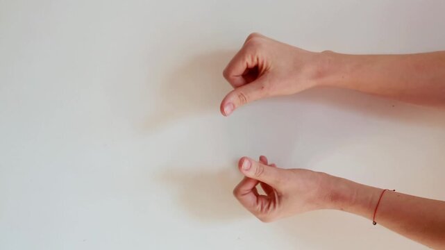 Female hands showing money request gesture isolated on white background. Close-up human gesture symbolizing asking for money, payment or financial concept.