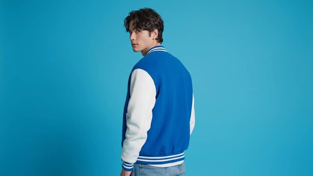 Man in blue jacket looks back.