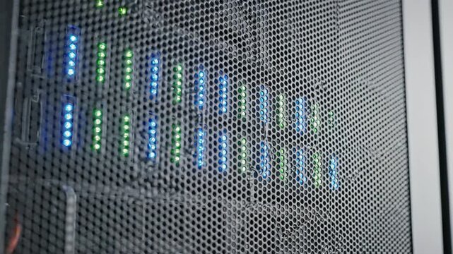 Server network with illuminated LED indicators showing connectivity status, wires, and ventilation. Server infrastructure is crucial for data management and technology solutions.
