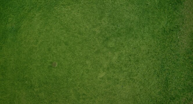 Birds eye view of a well maintained golf course turf with rich green grass for an authentic nature backdrop
