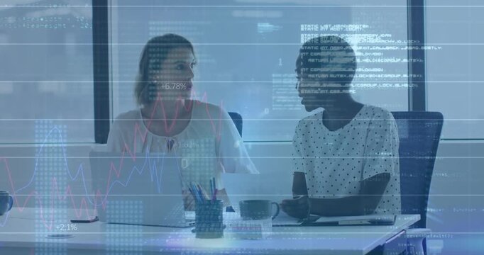Office woman gesturing at laptop showing finance overlay charts while colleague raising hand