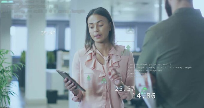 Mid adult woman pointing at colleague, swiping tablet, seeing CO? icons appearing for tech analysis