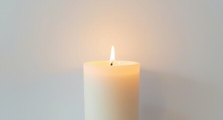 Burning fragrant candle glowing gently against an unadorned white surface