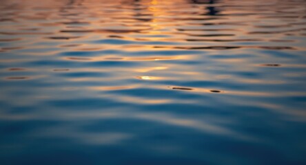 Calm swimming pool with blurred gentle ripples reflecting a warm and peaceful sunset