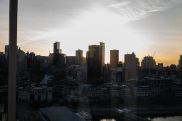 Fototapeta premium The city skyline is juxtaposed against a vibrant sunset, the buildings catching the warm colors of the sky, symbolizing urban growth and the beauty of daily transitions.