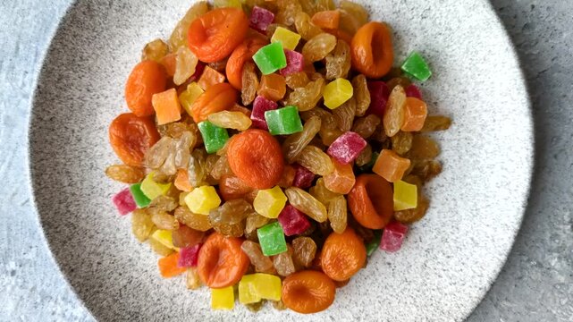 Dried apricots, raisins, and candied fruits as ingredients for baked goods and sweets. Dried fruits as a food background for your design