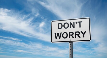 Fototapeta premium Dont Worry board with a serene sky filled with layered clouds in the background