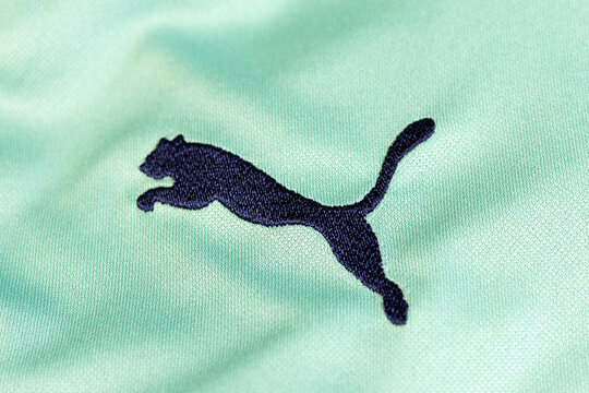 KYIV, UKRAINE - March 05, 2026 : Puma brand name. Close up, company logo on green sportswear fabric.