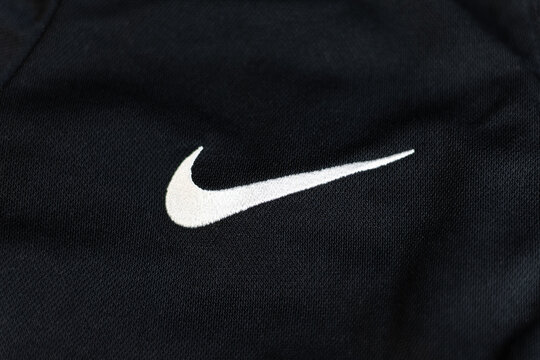 KYIV, UKRAINE - March 05, 2026 :  White Nike logo embroidered on black textured sports fabric.