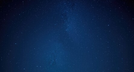 Obraz premium Captivating star studded night sky with sparkling cosmic lights on a rich blue background