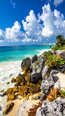 Obraz premium Rocky shoreline meets the turquoise sea under a bright blue sky with fluffy clouds