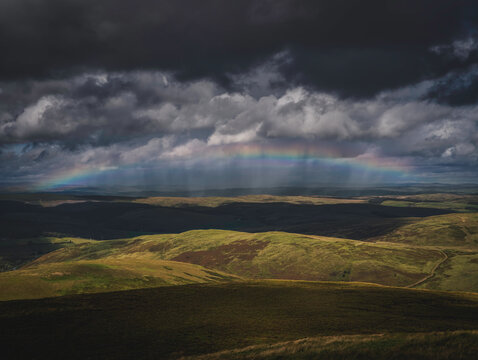 dramatic rural view with rainbow