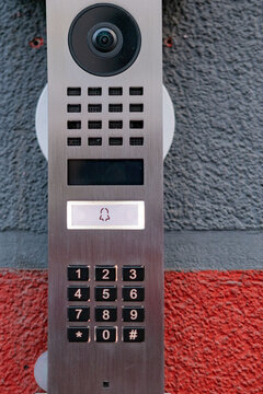 Video intercom with camera and speaker on wall, security access control terminal, door entry system, building entrance technology, Smart technology surveillance equipment, modern intercom device