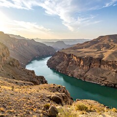 A scenic vista showcasing a wide, serpentine river cutting through towering canyon walls under a partly cloudy sky