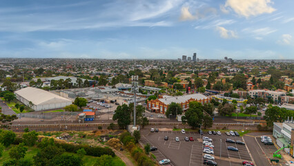 Obraz premium Panoramic Aerial Drone view of Inner Suburbs of Melbourne housing, roof tops, the streets and the parks, the roads and trees of Ascot Vale Moonee Ponds Brunswick Essendon and Maribyrnong in VIC Victor