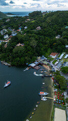 Fototapeta premium Aerial Waterfront Village Boats Restaurants Atlantic Forest Hills Lagoa Da Conceicao Florianopolis Brazil Island Coastal Scenery Santa Catarina South America Travel Destination