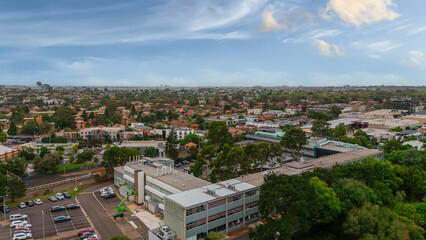 Fototapeta premium Panoramic Aerial Drone view of Inner Suburbs of Melbourne housing, roof tops, the streets and the parks, the roads and trees of Ascot Vale Moonee Ponds Brunswick Essendon and Maribyrnong in VIC Victor