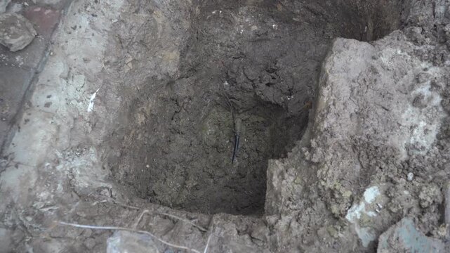 Repair of a water pipe break, Repairing a leaking water pipe in a deep pit at a construction site