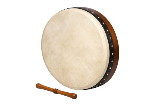 Traditional hand drum with a light skin surface and wooden rim alongside a matching stick for playing product shot isolated