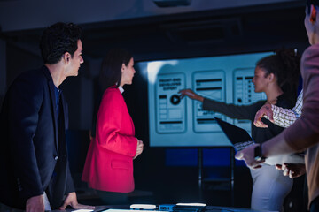 Empowering diverse STEM workforce. Engineering team analyzing interactive digital layouts. Driving...