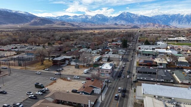 CALIFORNIA - 2.24.2026 - Wonderful aerial footage moving over the city of Bishop, California, towards snow-capped mountains.