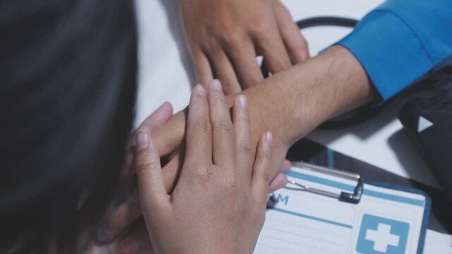Physiotherapist holds elderly patient&rsquo;s hands, offering emotional support and encouragement, creating a trusting relationship that fosters confidence in recovery.
