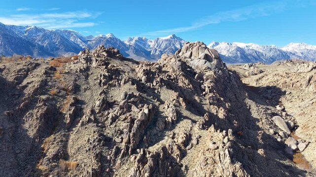 CALIFORNIA - 2.24.2026 - Incredible aerial footage cresting over rock formations in the Sierra Nevadas to reveal snow-capped peaks.