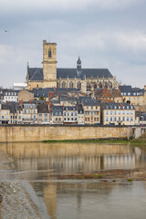 Fototapeta premium Nevers cathedral and city reflecting in river Loire