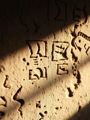 Chiseled stone whispers ancient secrets, aged by millennia of sun and shadow Macro focus reveals forgotten glyphs, bathed in ethereal light,  art,  macro
