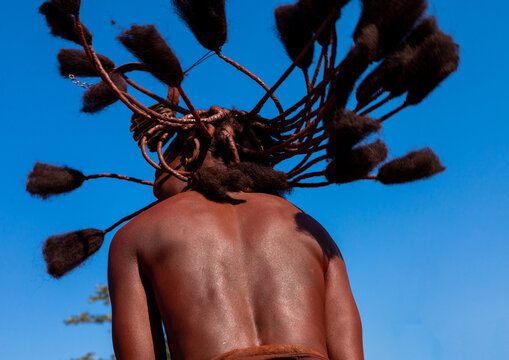 Batwa tribe woman dancing and playing with her dreadlocks, Cunene Province, Oncocua, Angola