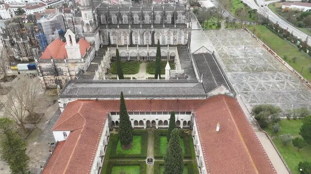 Drone flight above cloisters and Gothic roof of Batalha Monastery