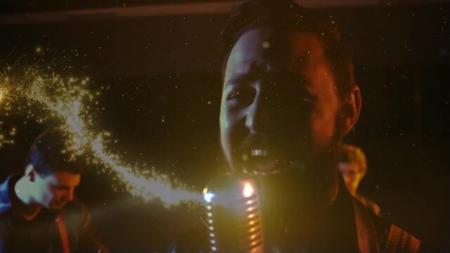 Singer starting song, guitarist strumming, drummer keeping tempo for music, gold swirl pulsing mic