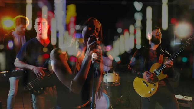 Lead singer gripping mic and starting song, causing double-exposure bokeh shifting over music