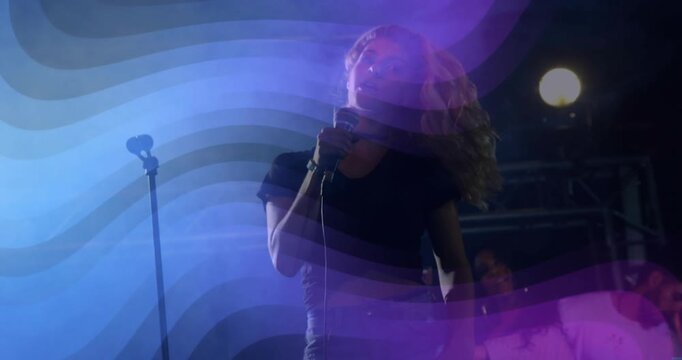 Music cue starting female singer tilting and tossing head, performing song, lights sweeping
