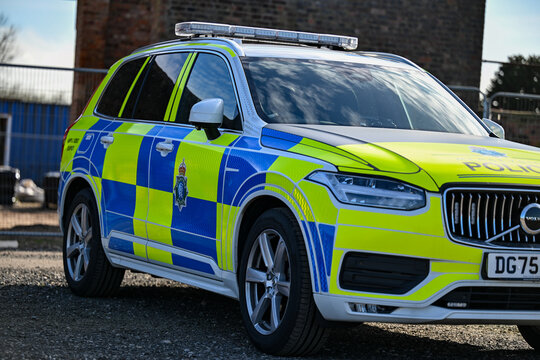 A parked Merseyside Police ANPR emergency traffic car showing the hi-visibility yellow and blue reflective batternberg.