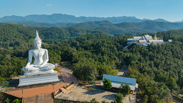 The historic stupa of Wat Phra That Pu Jae in Phrae Province is a centuries old sacred site situated on a mountain. The square chedi enshrines a revered relic of the Buddha and represents 
