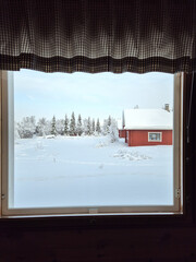 Fototapeta premium Winter wonderland view from a cozy cabin in Akaslompolo, Lapland, Finland