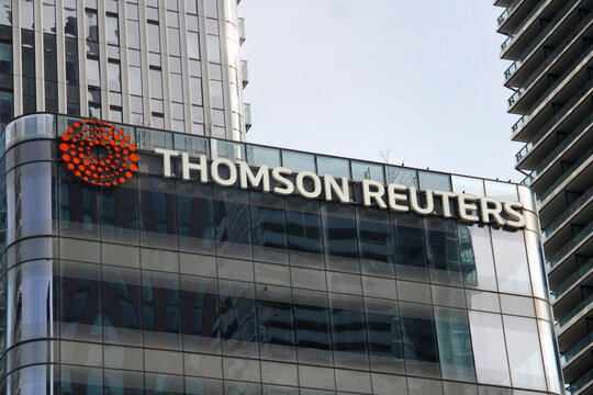 Toronto, Canada - February 15, 2026: Thomson Reuters office building facade with logo in downtown Toronto financial district surrounded by modern glass skyscrapers