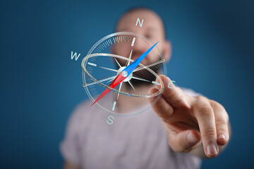 A person interacting with a holographic compass, suggesting direction, guidance, and navigation...