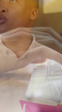 Vertical video: Woman turning pink notebook, man typing, speaking, keys reflecting for office team