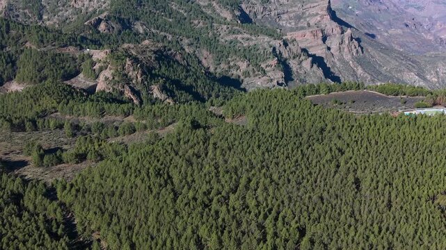 Aerial view from Ganifa arch revealing the iconic Roque Nublo in Gran Canaria, with Teide volcano on the horizon