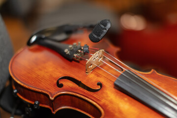 Fototapeta premium Violin with microphone setup during music recording session in a studio environment