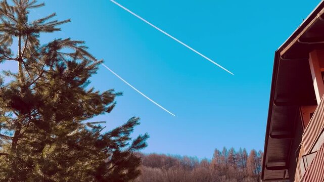 Italy, Limone Piemonte, February 26, 2026. 
Airplanes with Contrails in Blue Sky &ndash; Aviation Background.
 Djundiet A. 