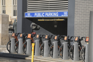 Naklejka premium Bike Share Toronto docking station near entrance to Public Parking at 180 Wellington St W