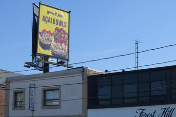 Naklejka premium rooftop billboard for Booster Juice above Black Bear Pub, at 1125 O'Connor Dr, East York, Toronto