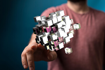 A person holds a futuristic digital cube representing concepts like data, technology, connection...