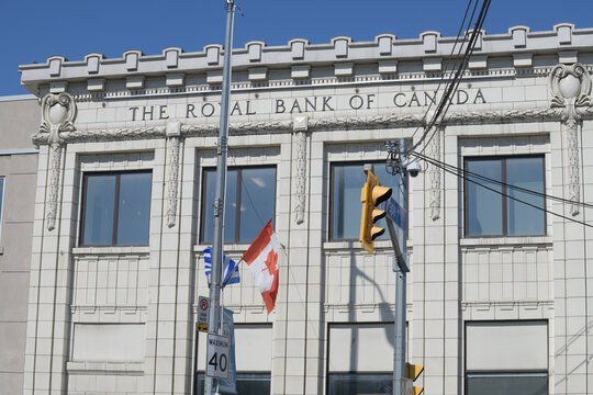 exterior facade and inscription sign of The Royal Bank of Canada, a heritage branch, designed by Bond & Smith, 1925, located at 646 Danforth Av, Toronto