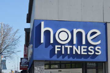 Naklejka premium exterior wall and sign outside Hone Fitness Pape & 603 Danforth Av, Toronto