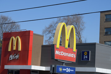 Naklejka premium iconic Golden Arches sign outside a location of McDonald's Canada fast food restaurant at 1045 Pape Av, Toronto
